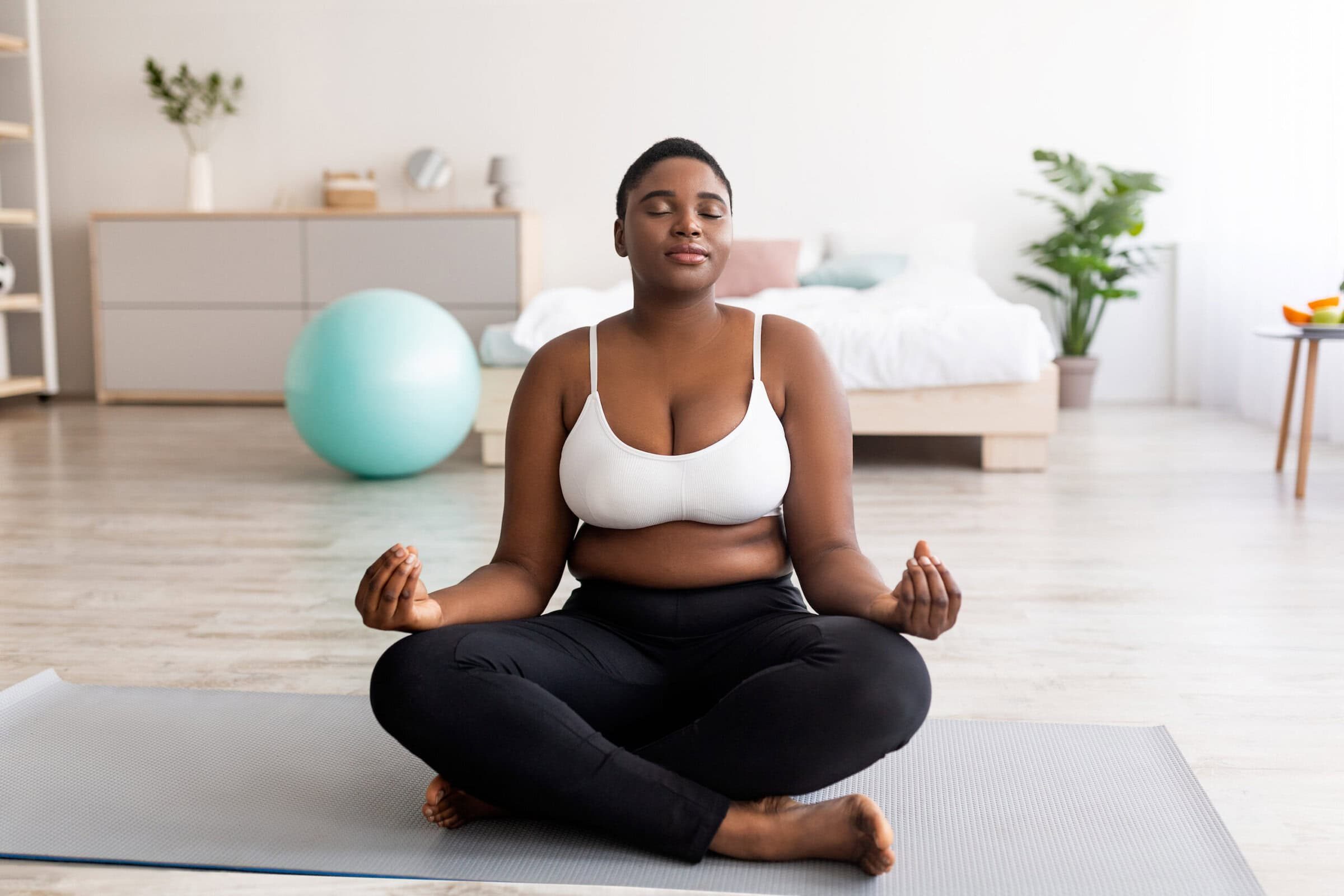 Plus,Size,Black,Woman,Sitting,In,Lotus,Pose,,Meditating,With