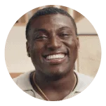 Smiling man in a light-colored shirt with a gold chain, set against a circular coral background. Represents positivity, confidence, and the supportive Noom community.